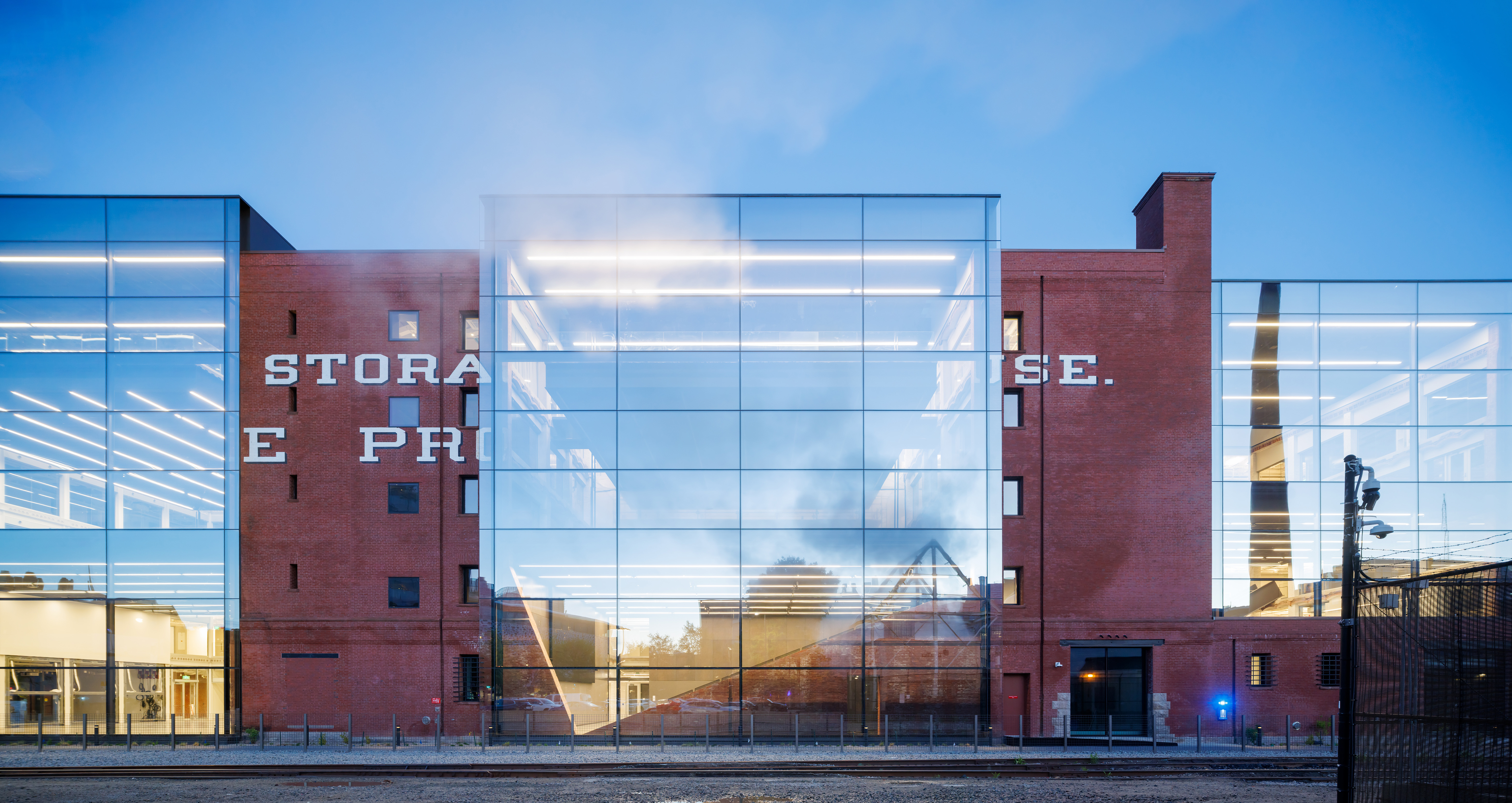 Metropolitan Storage Warehouse, north facade viewed at sunset; glass reflects light. 