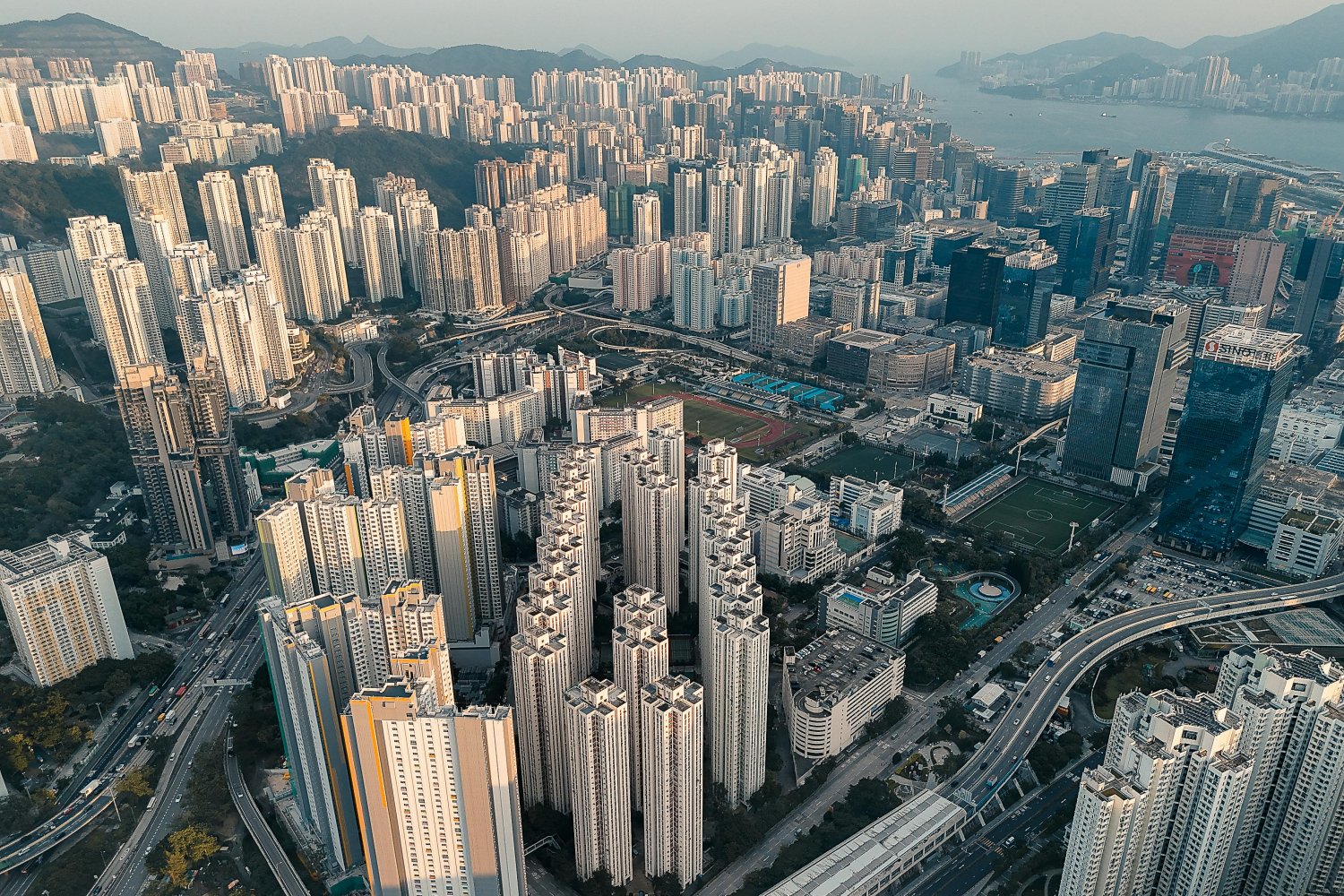 A dense high-rise development in Kowloon, Hong Kong, reflects the speed and scale of urbanization across Asia, where cities are expanding rapidly to accommodate growing populations.