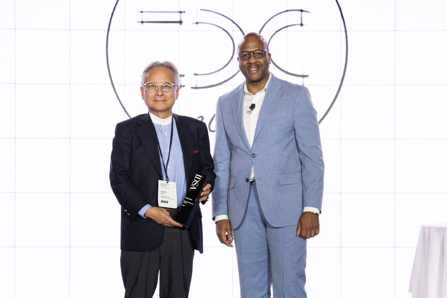IDSA CEO Donté P. Shannon (right) presents Professor Hiroshi Ishii with the 2026 Special Achievement Award for three decades of research integrating physical and digital environments.