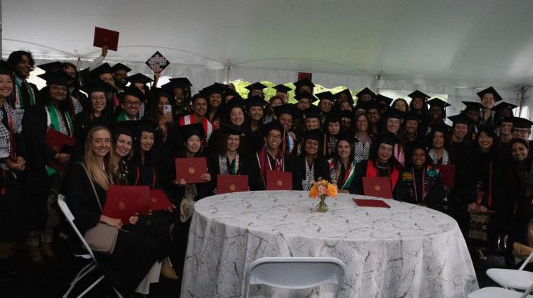 Group of graduates pose for photo at reception 