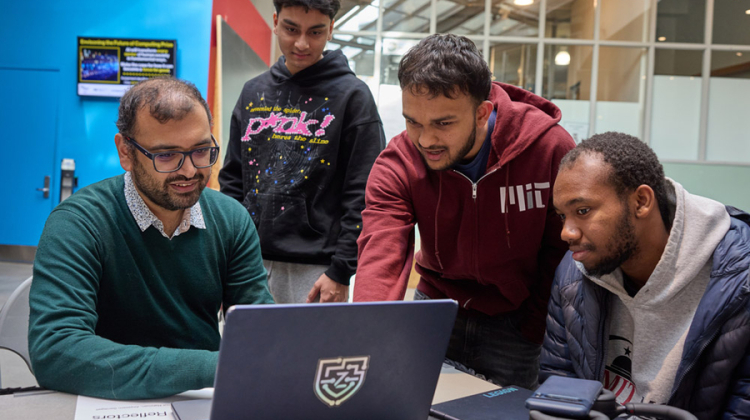 4 students working with a computer