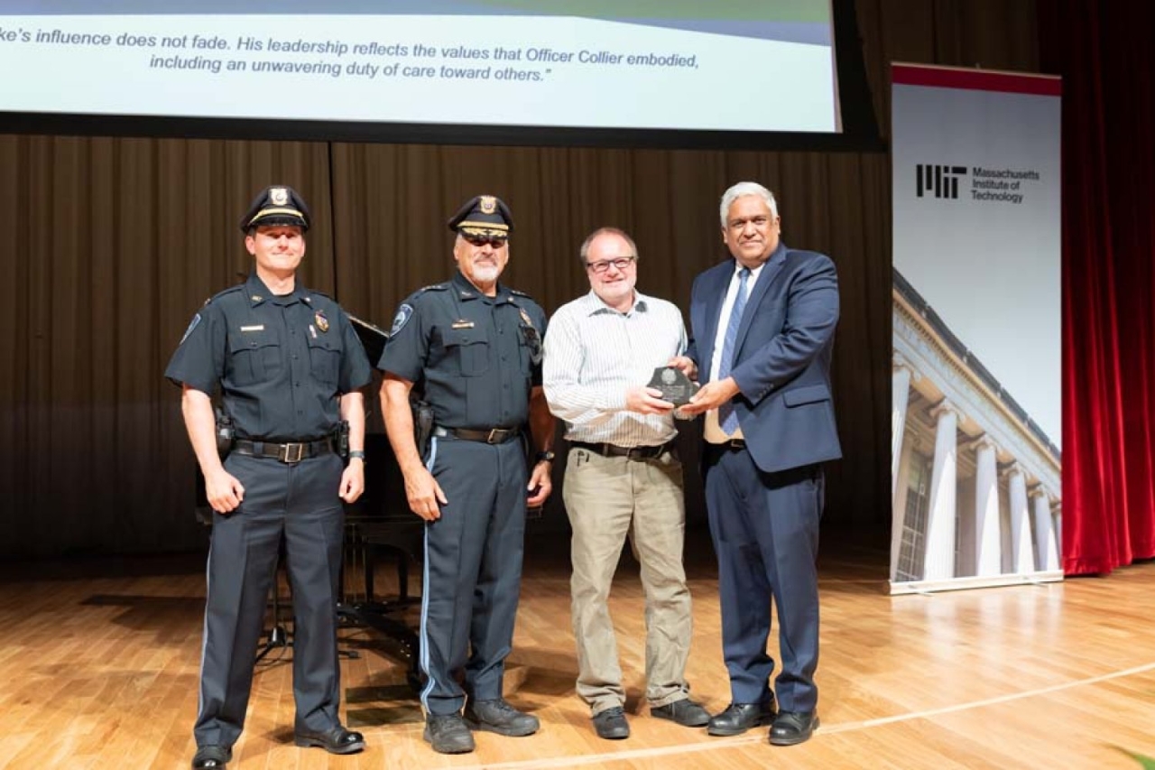 Collier Medal recipient Michael Grenier (second from right) receives his award from (left to right) MIT Captain Andrew Turco, Chief of Police John DiFava, and Provost Anantha Chandrakasan.