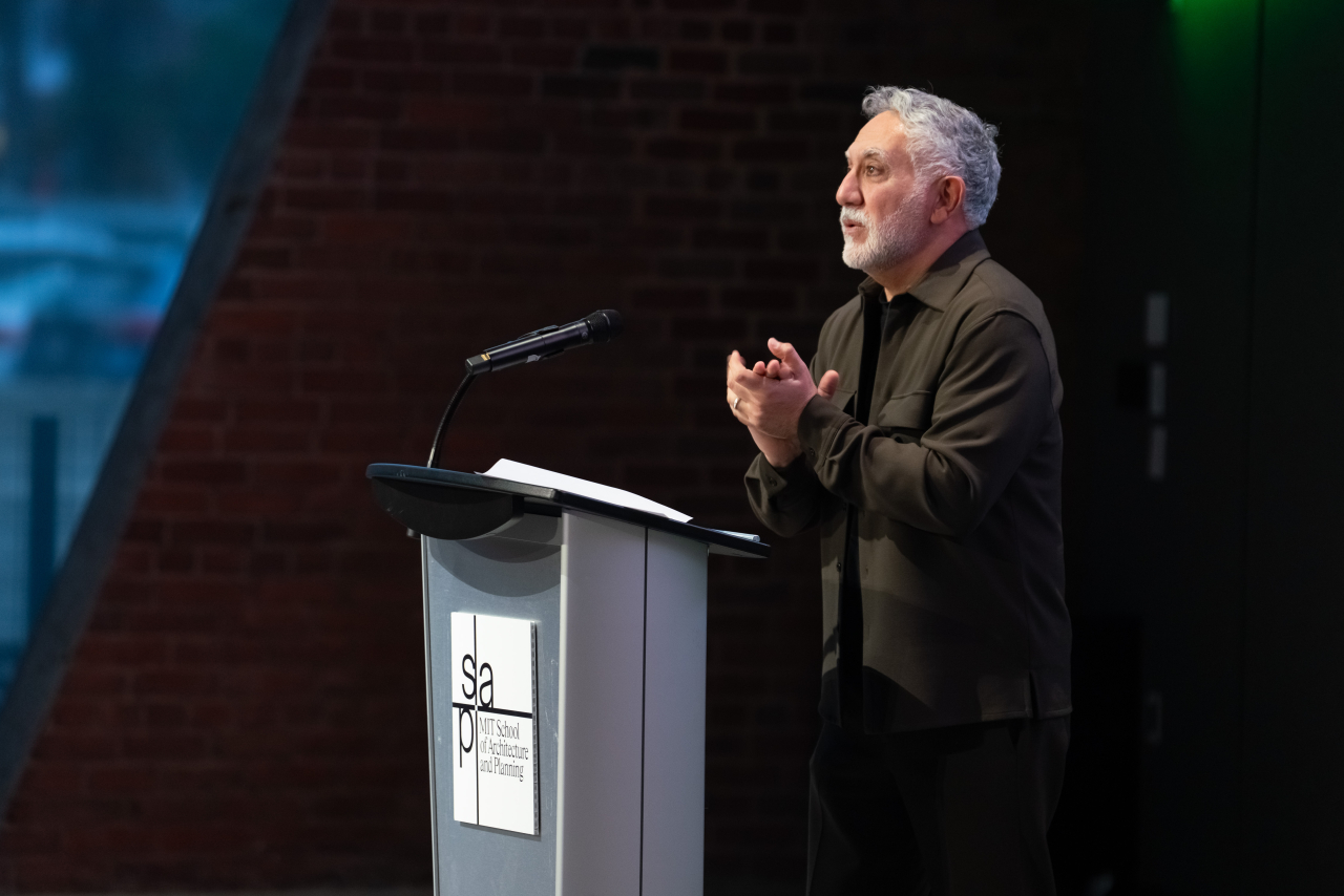 MIT School of Architecture and Planning Dean Hashim Sarkis speaks at a podium during the MET Warehouse dedication ceremony.