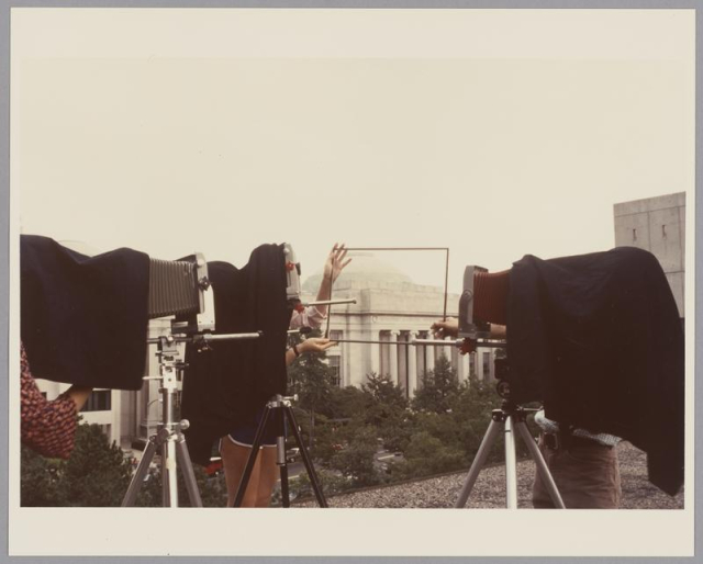 Photo of Visual Arts students taking a photograph of Building 7.