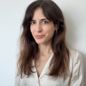 Headshot of Mehves Lelic; woman with mid-length brown hair, wearing a white shirt